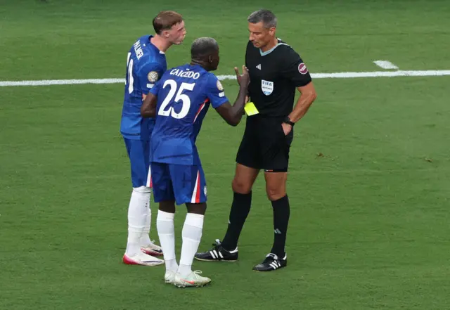 Moises Caicedo is shown a yellow card