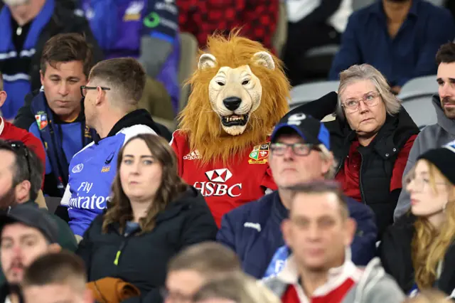 A British and Irish Lions supporter wears a mask