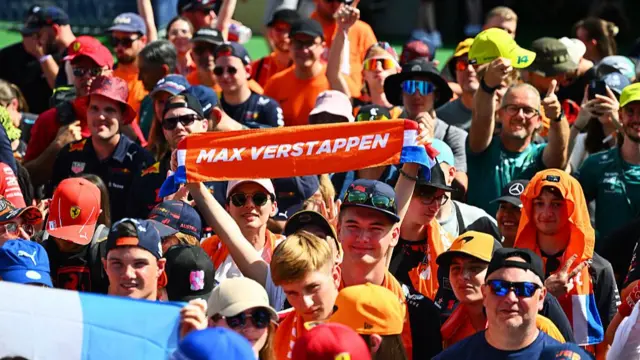 fan holds up a Max Verstappen banner