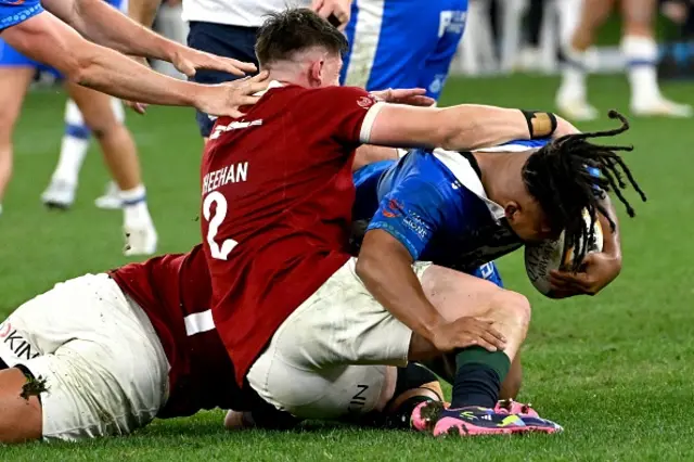British and Irish Lions' player Dan Sheehan (L) tackles Western Forces' Brandon Paenga-Amosa