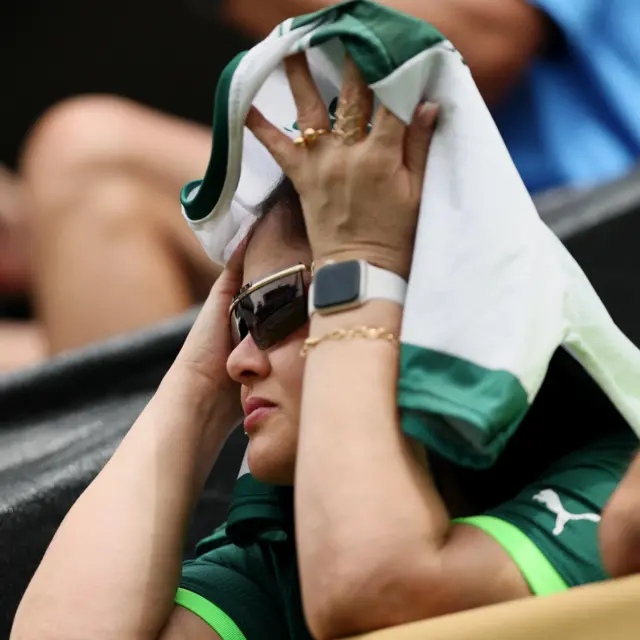 Palmeiras fan puts her hands to her head