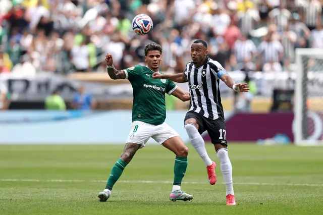 Freitas and Rios jostle for position while the ball flies towards them