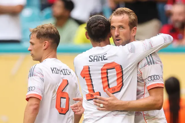 Harry Kane hugs Leroy Sane after his second goal