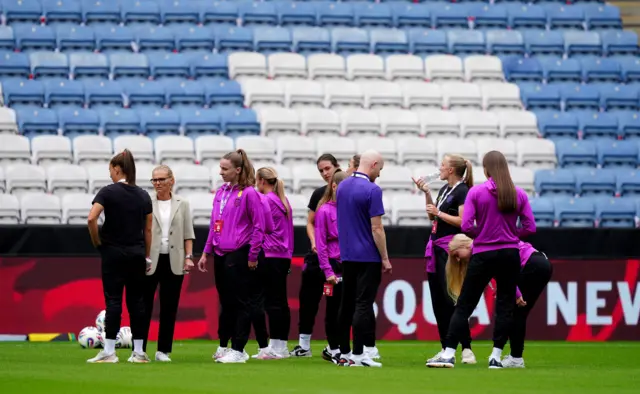 England's manager Sarina Wiegman and her team inspect the pitch before a women's international friendly match at the King Power Stadium, Leicester.