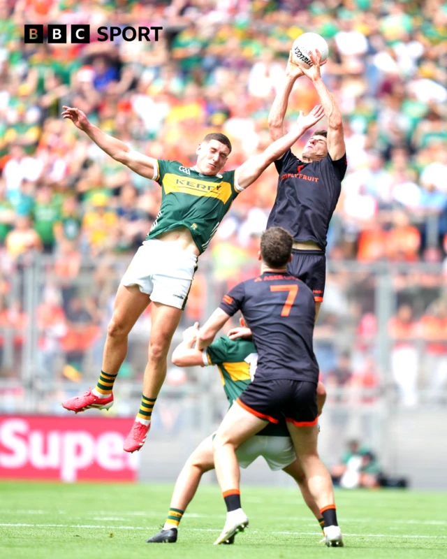 Niall Grimley of Armagh catches a kick out ahead of Joe O'Connor of Kerry