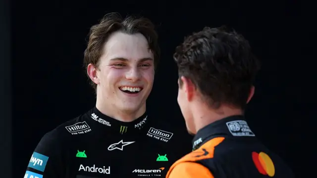 Oscar Piastri speaking to Lando Norris