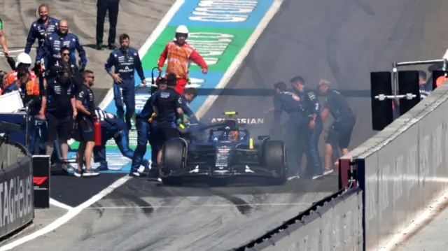 Carlos Sainz car on fire at the pitlane