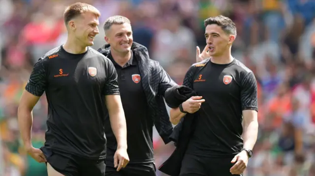 Armagh players share a joke as they inspect the pitch