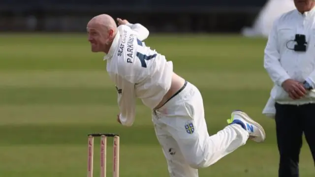 Callum Parkinson bowling for Durham