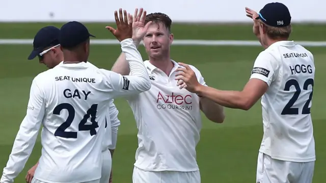 Jimmy Neesham takes a wicket for Durham