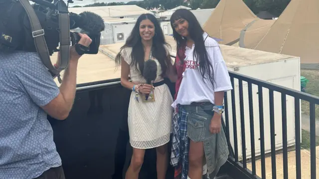 BBC's Noor Nanji, holding a microphone, pictured with Joy Crookes