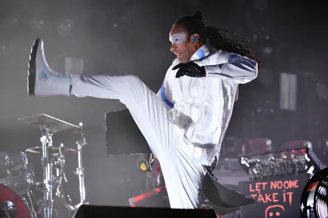 Maxim facing left and kicking up in the air with his right leg