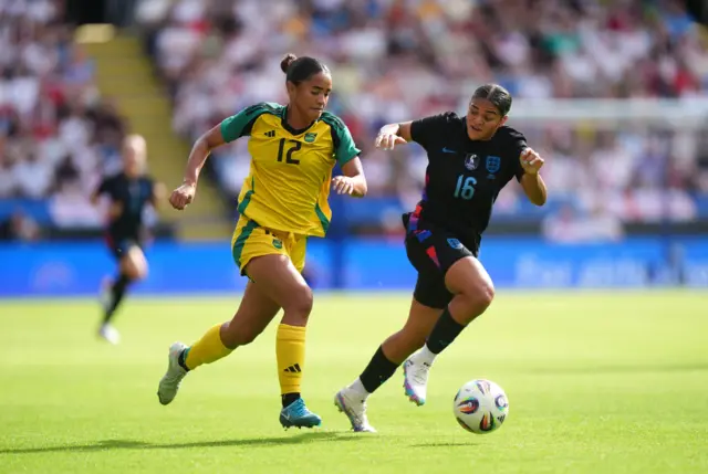 Jamaica's Kalyssa Van Zanten (left) and England's Jess Carter battle for the ball