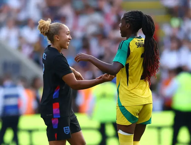 England's Lauren James with Jamaica's Vyan Sampson after the match