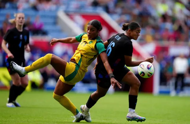 Jamaica's Kameron Simmonds and England's Jess Carter (right) battle for the ball
