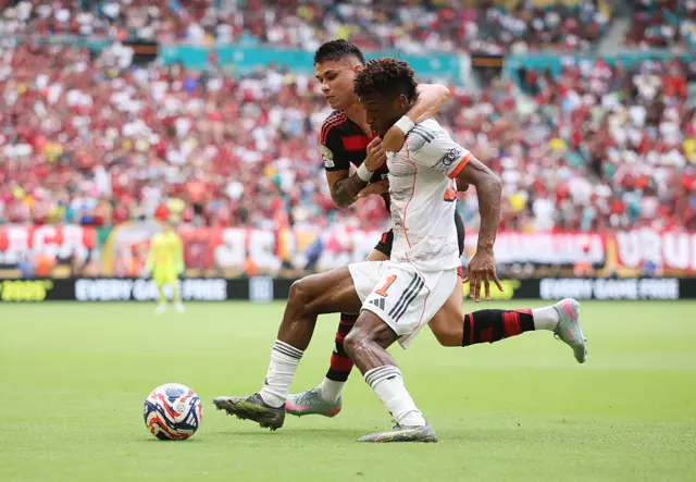 Kingsley Coman is challenged by Luiz Araujo