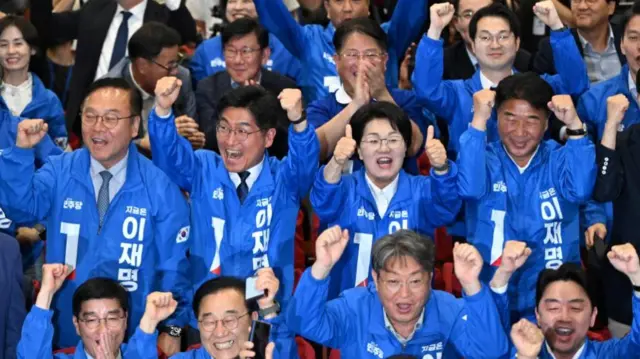 Dressed in bright blue party jackets, DP members are all smiles - some punching their firsts into the air - as first exit polls come in