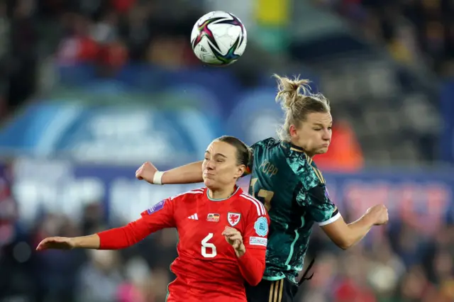 Josie Green competes for a header during Wales' game with Germany in Swansea in 2023