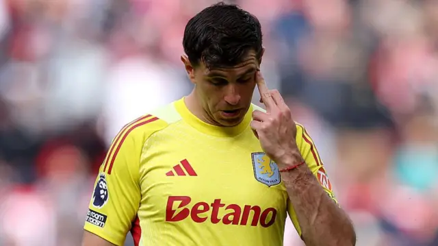 Emiliano Martinez of Aston Villa reacts after being shown a red card