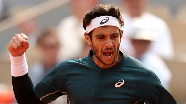 Lorenzo Musetti celebrates his victory over Frances Tiafoe