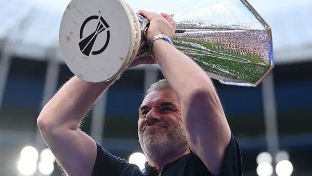 Ange Postecoglou, Manager of Tottenham Hotspur, lifts the UEFA Europa League trophy,