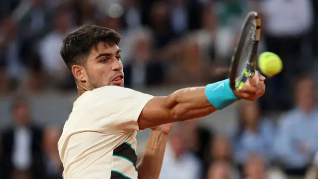 Carlos Alcaraz plays a forehand return
