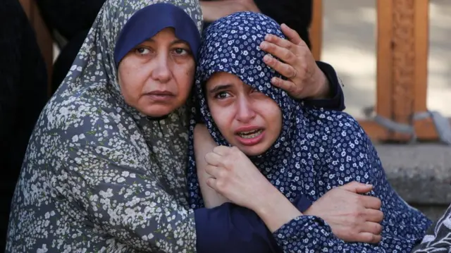 Women react following the incident
