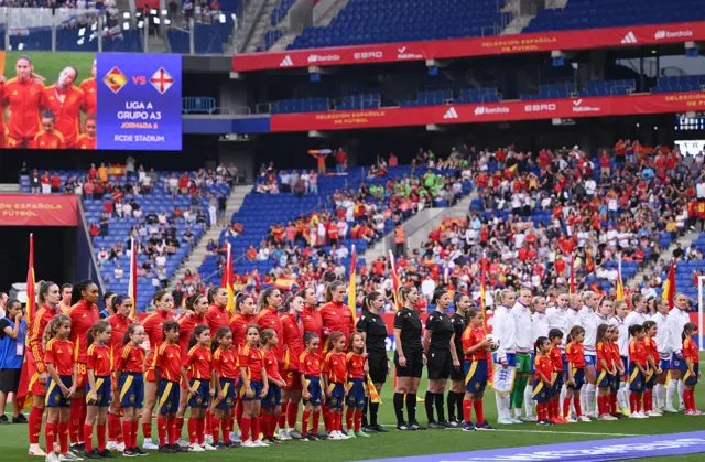 The teams stand for the anthems
