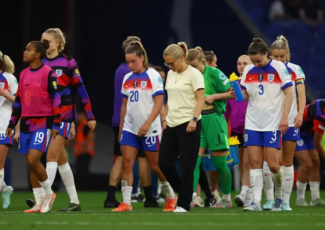 Wiegman trudges around the pitch with her players