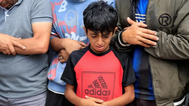 A young boy cries after reports of a deadly shooting in Rafah