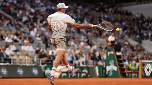 Tommy Paul plays a forehand return