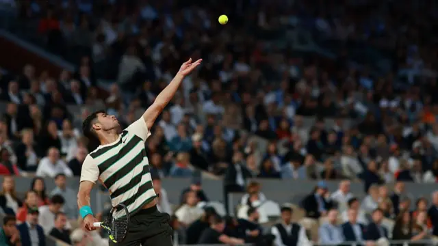 Carlos Alcaraz hits a serve