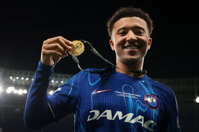 Jadon Sancho hold a Conference League medal
