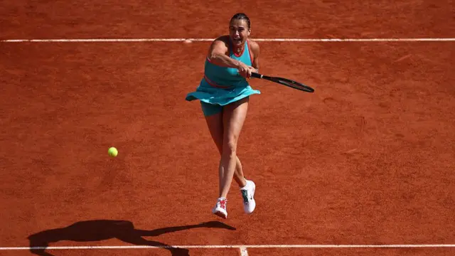 Aryna Sabalenka plays a forehand return