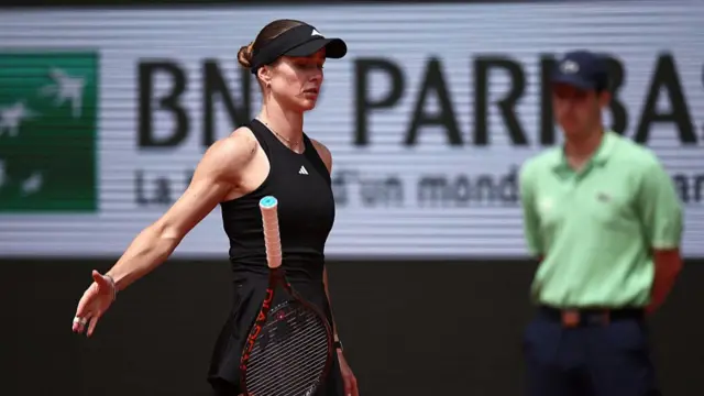 Elina Svitolina throws her tennis racquet