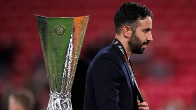 Ruben Amorim, head coach of Manchester United FC, looks dejected next to the trophy