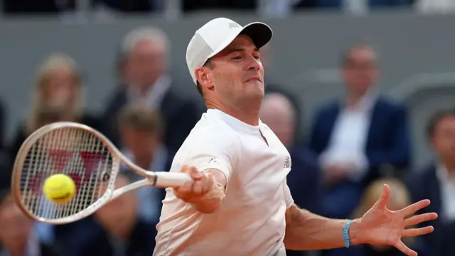 Tommy Paul plays a forehand return
