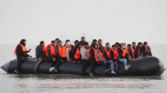 A group of people thought to be migrants onboard a small boat leaving the beach at Gravelines, France, attempting to reach the UK by crossing the English Channel