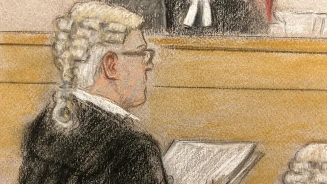 A sketch shows a lawyer, dressed black robes, reading off a piece of paper