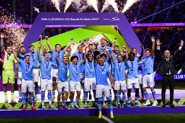 Manchester City squad celebrates with the winners trophy
