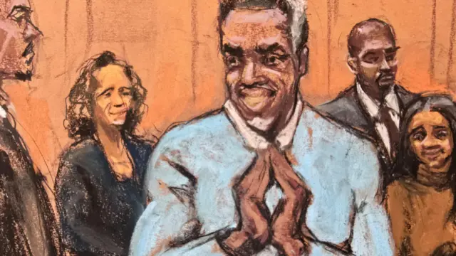 A court sketch of Sean "Diddy" Combs holding his hands together while surrounded by his legal team
