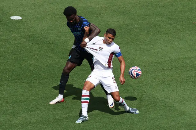 Thiago Silva of Fluminense FC is challenged by Marcus Thuram