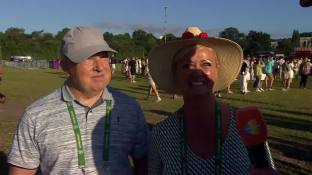 Nigel and Vicky at Wimbledon with their number one and two tickets around their necks