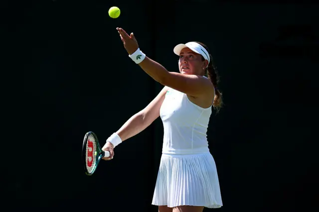 Jelena Ostapenko throws the ball to serve