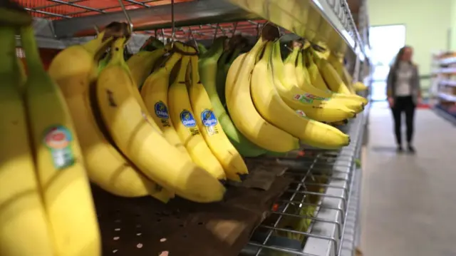 Bananas on a rack in a supermarket