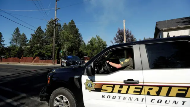 Kootenai County Sheriff's vehicle travels near an area where multiple firefighters were attacked in Coeur d'Alene, Idaho on 29 June 2025.