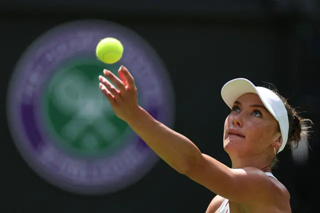 Carson Branstine seves at Wimbledon