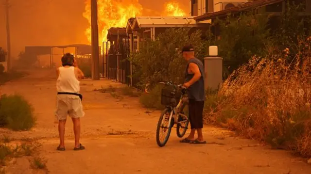 Flames rise from forest area after a wildfire broke out in Seferihisar district, Izmir, Turkiye