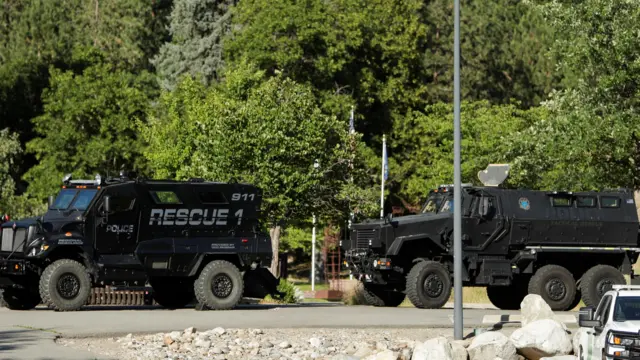 Armored law enforcement vehicles are seen at Cherry Hill Park