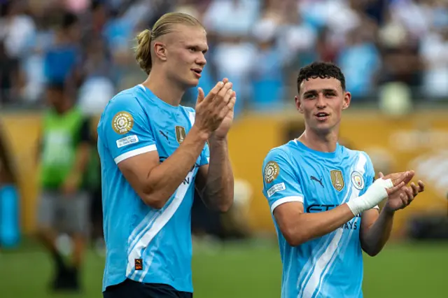 Erling Haaland #9 and Phil Foden #47 of Manchester City FC exit the pitch